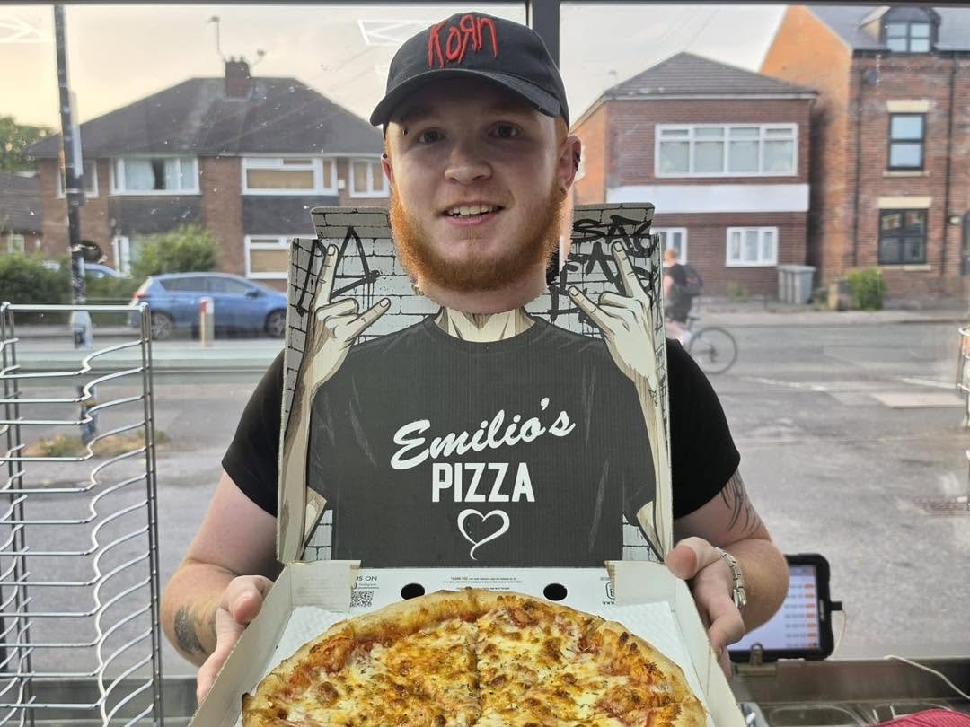 Emilios staff member using the custom pizza box photo prop